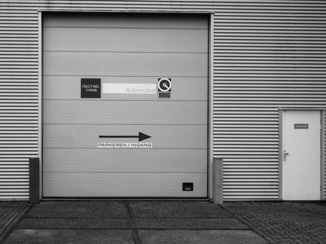 A black and white photo of a garage door A black and white photo of a garage door