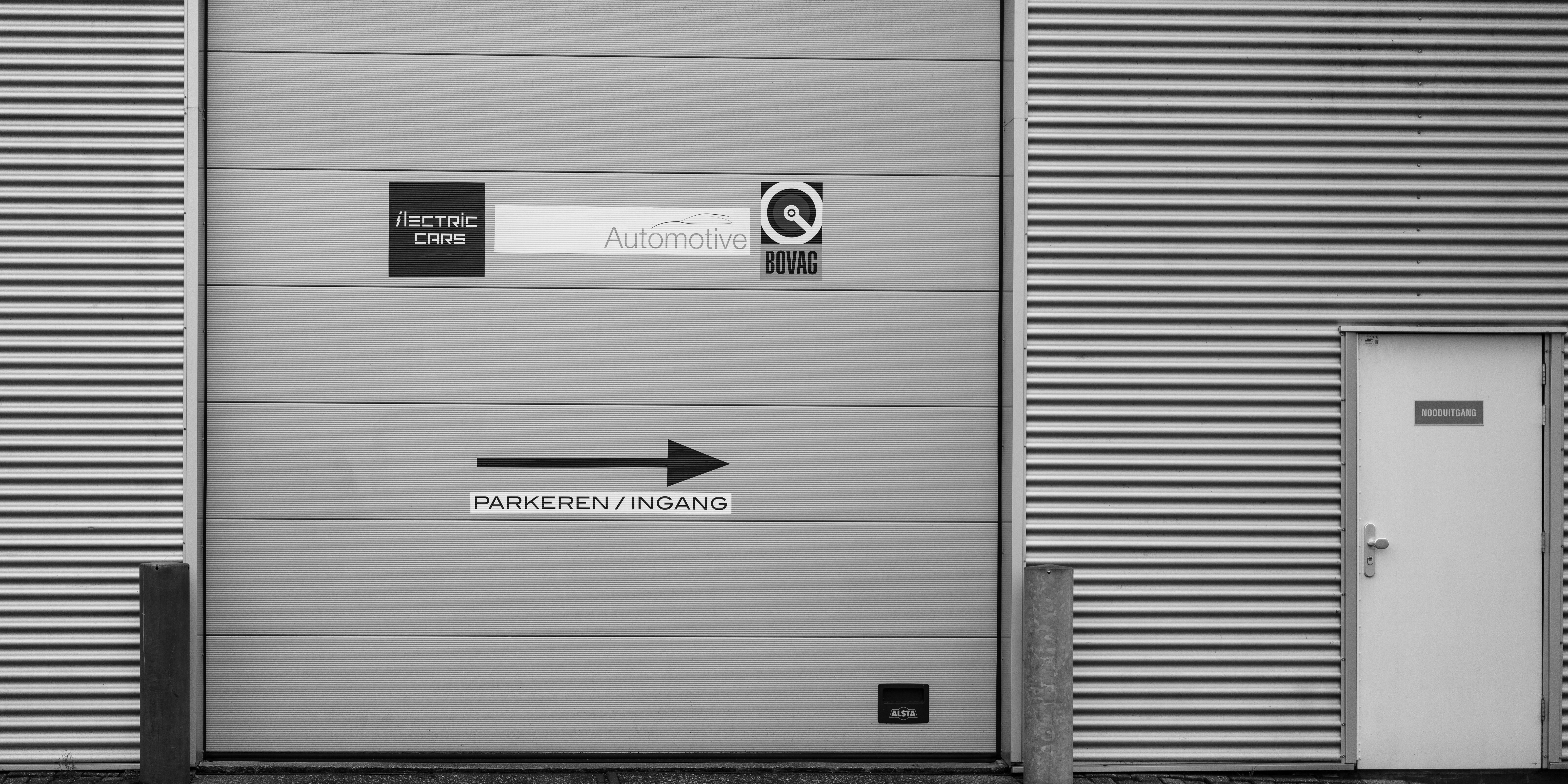 A black and white photo of a garage door