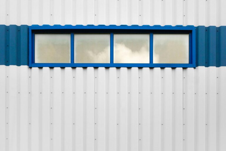 a white building with a blue window on the side of it