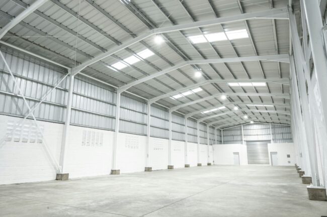 an empty warehouse with no people in it an empty warehouse with no people in it
