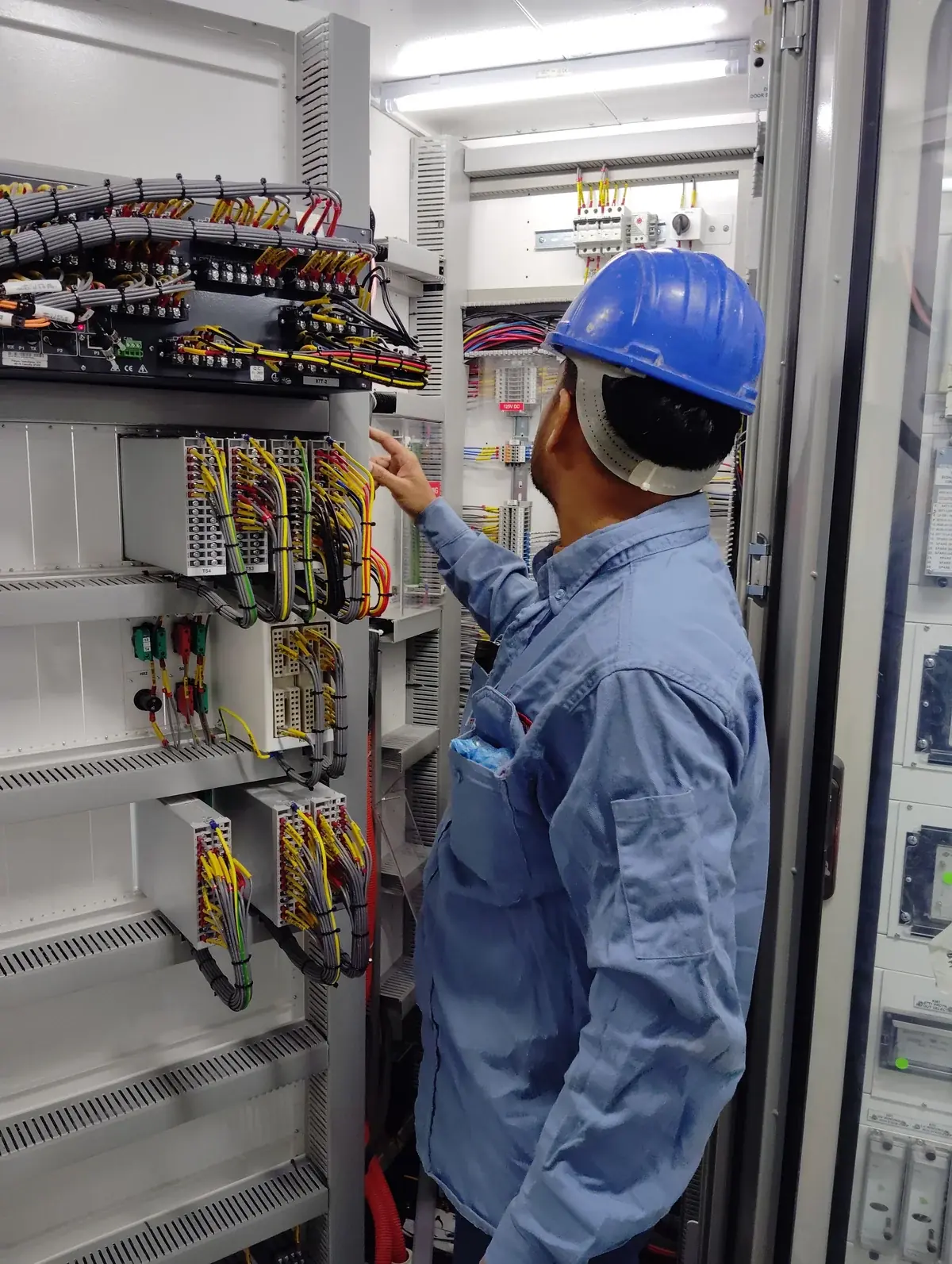 Factory technical auditor inspecting surface quality and dimensional tolerances of aluminum facade panels