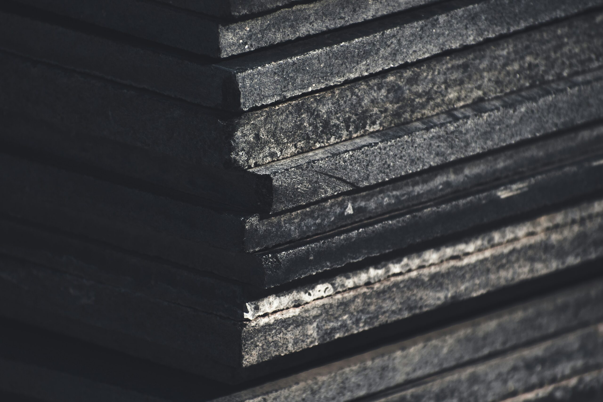 Hyper-realistic cross-section photography of a CFRT PU panel, clearly showing the thin, strong CFRT skin layers bonded to a thick, uniform polyurethane foam core. Macro shot, studio lighting, clean composition, no text, no brand logo.