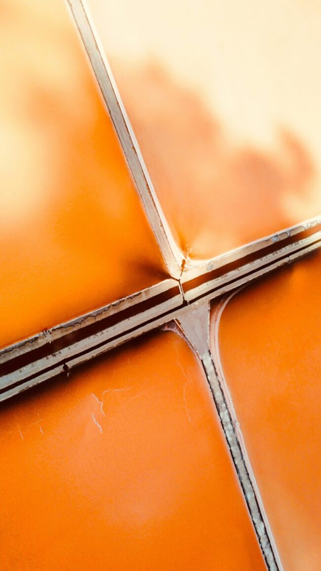 Hyperrealistic Photography Of A Crosssection Of A Firerated Overview Hyper-realistic photography of a cross-section of a fire-rated composite sandwich panel, showing distinct layers of core material and facing. The panel is partially charred on one side, with flames subtly visible in the background, emphasizing its fire-resistant properties. Clean composition, no text, no brand logos.