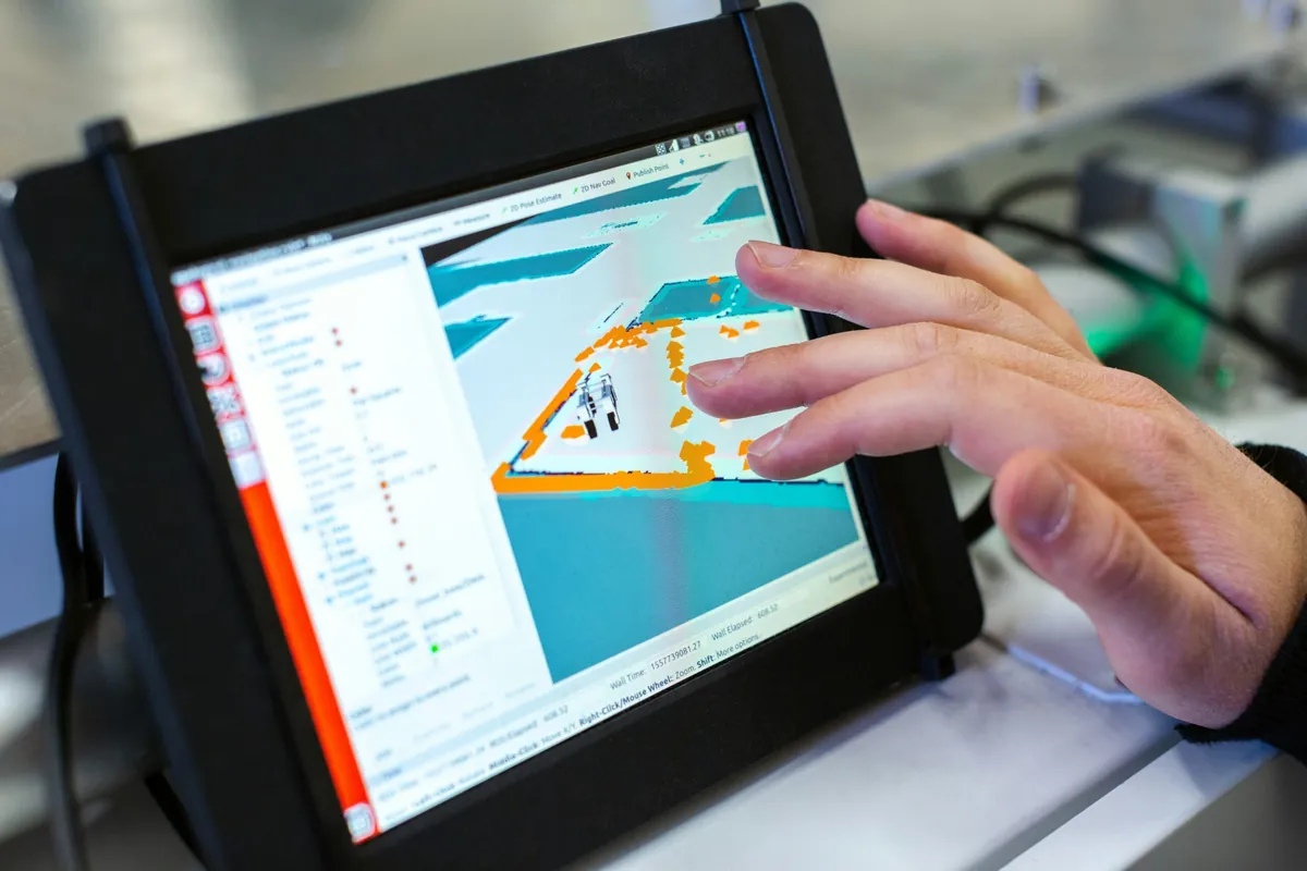 Hyper-realistic photography of an engineer or designer reviewing technical specifications and blueprints for fire-rated composite panels on a digital tablet or large screen. Various panel samples and material swatches are laid out on a desk, with a focus on detailed data and certifications. Clean composition, no text, no brand logos.