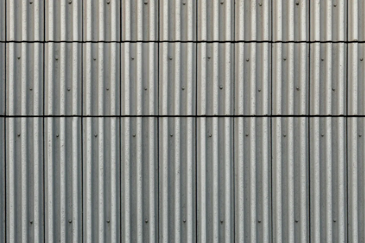 Hyper-realistic photography of the surface of a barn sandwich panel, showcasing different face material options like smooth FRP, textured GRP, and coated aluminum. The surfaces are clean and reflective, emphasizing durability and hygiene. A subtle light source highlights the different textures. Studio lighting, clean composition, no text, no brand logos.