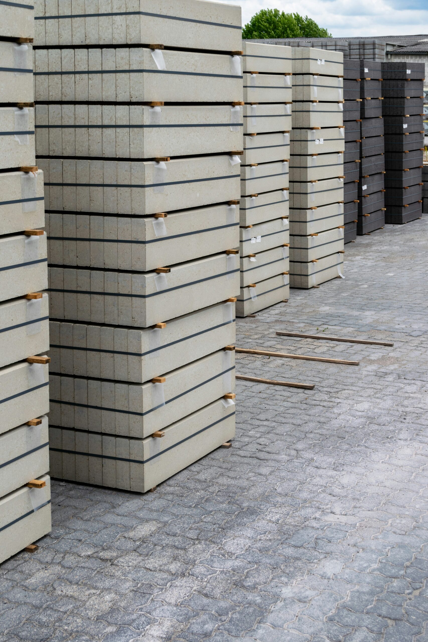 Hyper-realistic photography of various fire-rated agricultural panel materials arranged neatly, showcasing their different textures and compositions. Include samples of Rockwool Sandwich Panels, PIR Sandwich Panels, and Stainless Steel Sandwich Panels. Each sample should be clearly distinguishable, highlighting their robust construction and fire-resistant properties. The background is a clean, professional laboratory or workshop setting with subtle tools. Bright, analytical lighting. No text, no brand logos, clean composition.