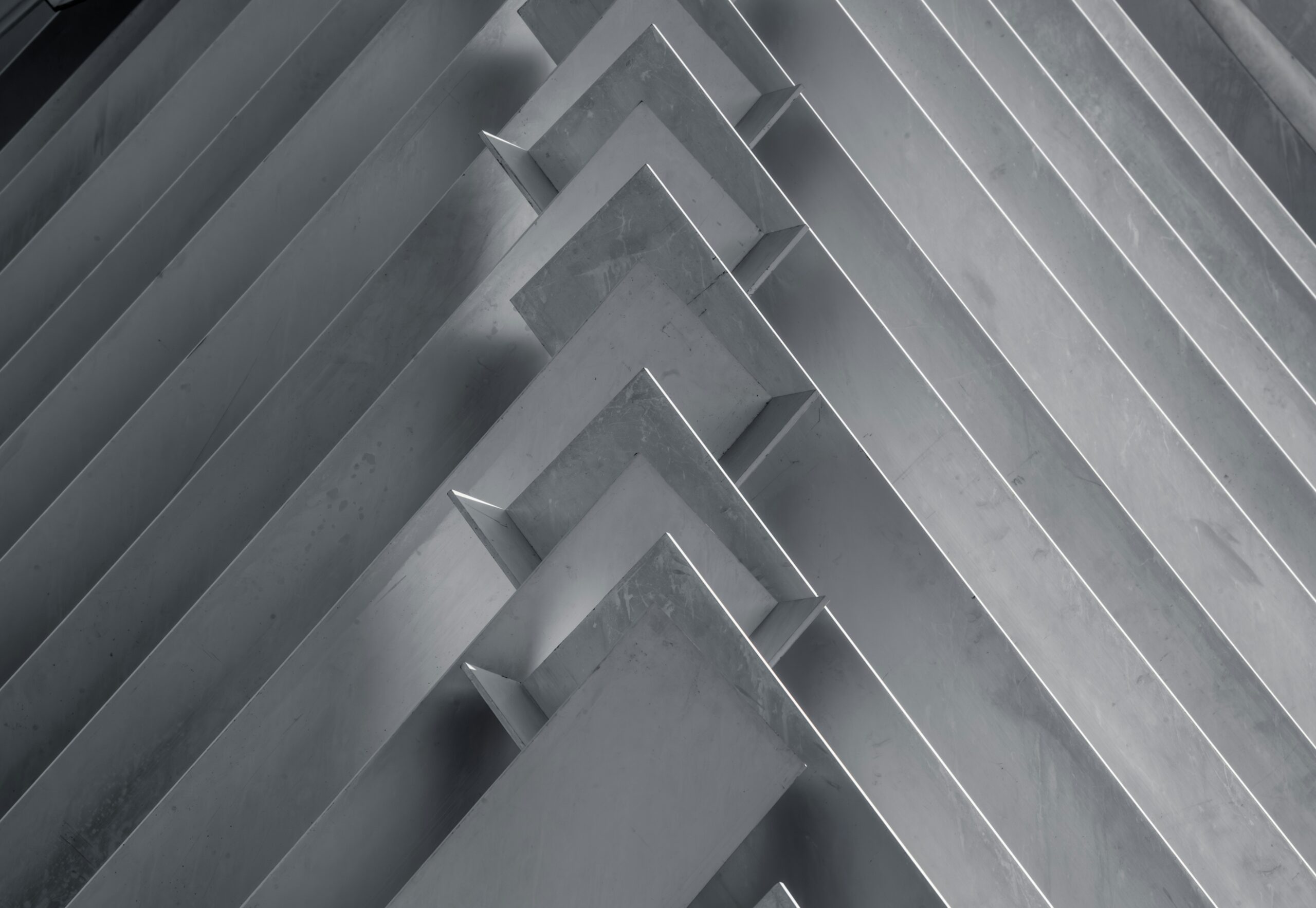 Hyper-realistic photography showcasing cross-sections of three distinct sandwich panels: one with a CFRT core, one with a GRP/FRP honeycomb core, and one with a foam core. Each cross-section is meticulously cut and displayed side-by-side on a dark, reflective surface, highlighting their internal structures and different material compositions. Sharp focus on the core materials, with soft, directional lighting emphasizing texture. Clean composition, no text, no brand logos. Illustrate the diverse offerings of aluminum sandwich suppliers.