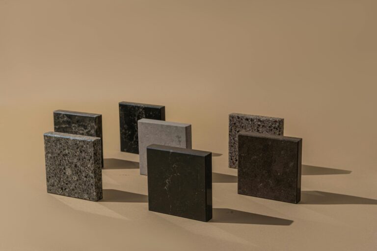 Hyper-realistic product photography of three distinct foam core samples: PMI, PET, and PVC, each clearly labeled and showcasing their unique textures and densities. The samples are arranged on a clean, white laboratory surface under bright, even lighting, with a subtle depth of field. No text, no brand logos, clean composition.