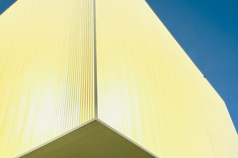 Hyper-realistic product photography of various fiberglass sandwich panels (CFRT, GRP/FRP honeycomb, foam core, aluminum) stacked neatly in a warehouse, showcasing different textures and thicknesses. Soft, diffused industrial lighting, clean composition, no text, no brand logos.