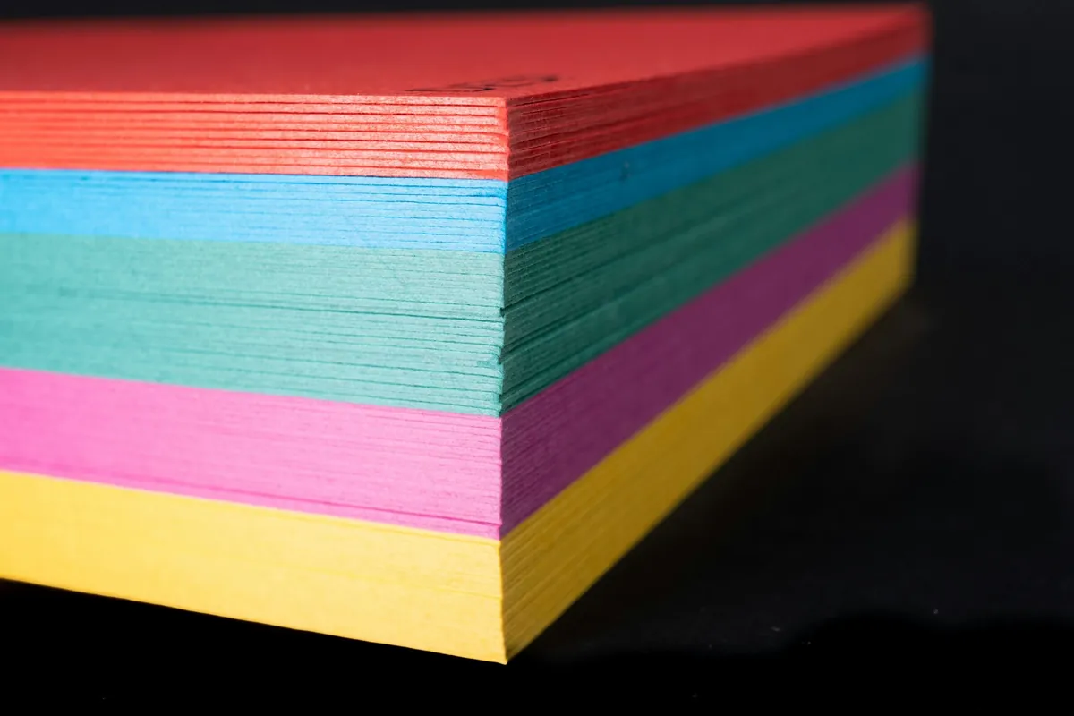 Hyper-realistic studio photography of a cross-section of a PVC foam core panel, clearly showing its uniform closed-cell structure, with a ruler placed alongside to indicate thickness, under bright, even lighting, clean composition, no text, no brand logos.
